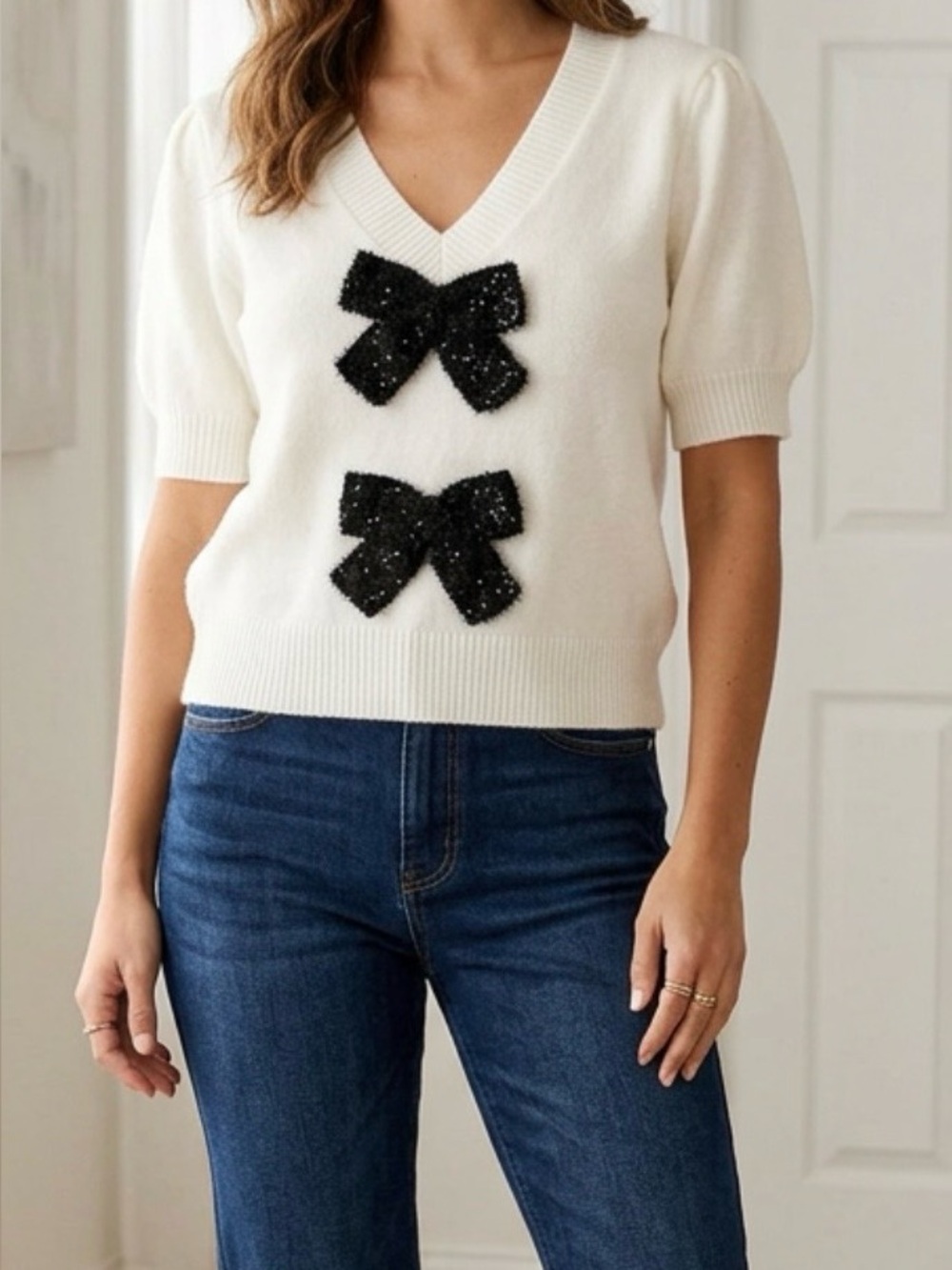 entro White V-Neck Short Sleeve Sweater with Black Bow Accents